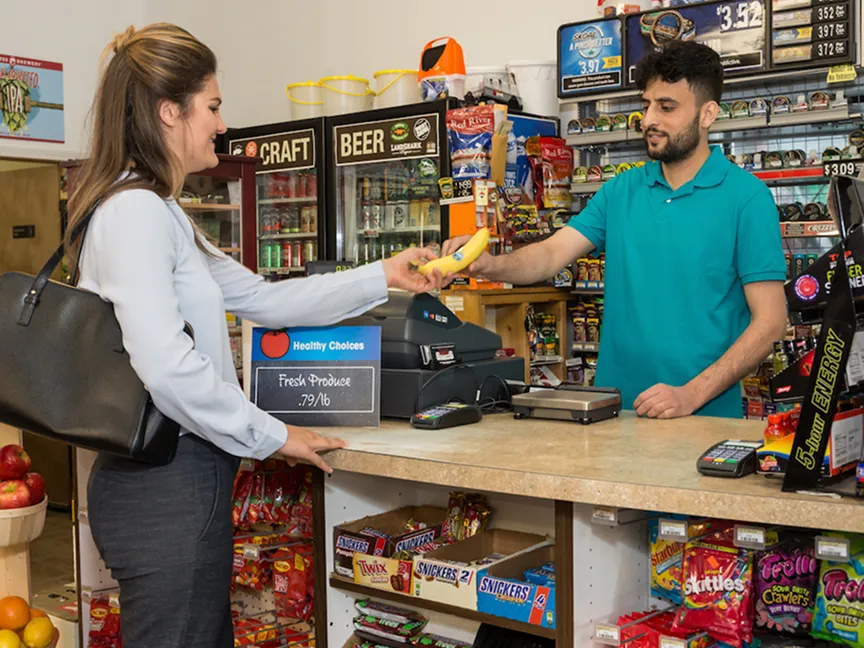  customer and cashier at checkout counter