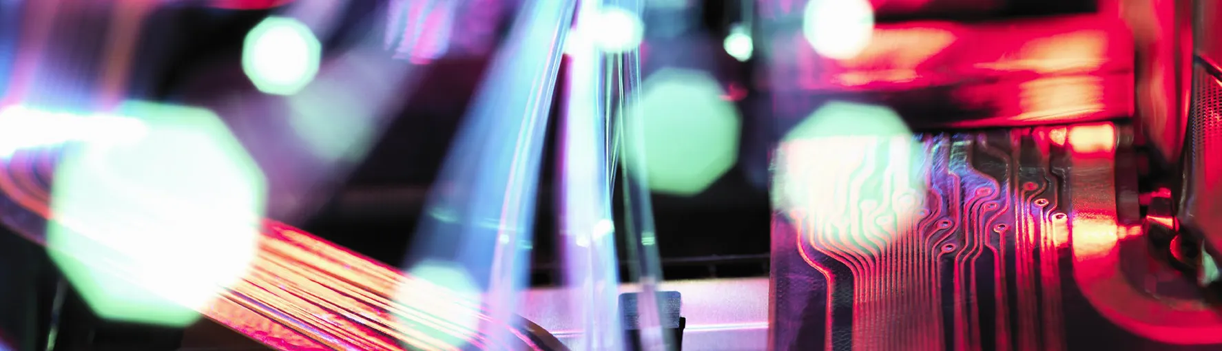Close-up image of a computer motherboard with neon lighting effects.